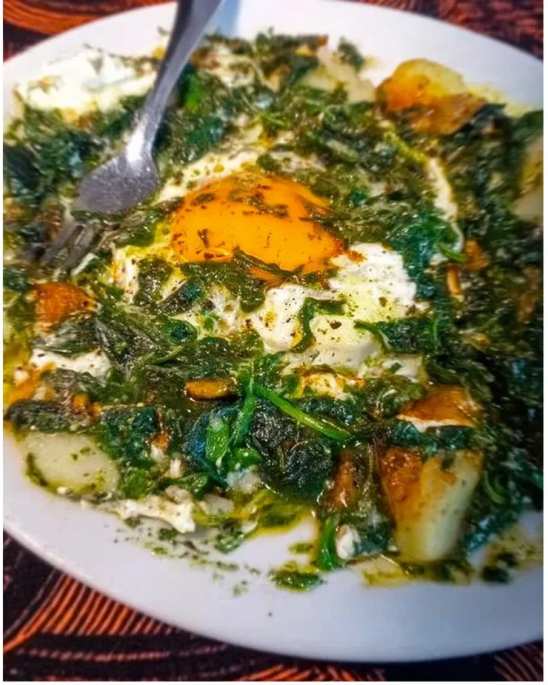 Kartoffeln mit Spinat und Ei auf einem Teller serviert