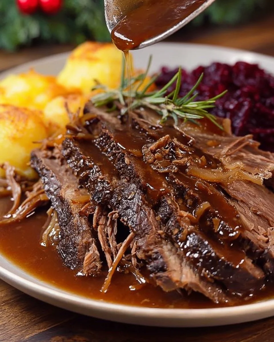 Ein Teller Sauerbraten mit Beilagen, traditionelles deutsches Gericht