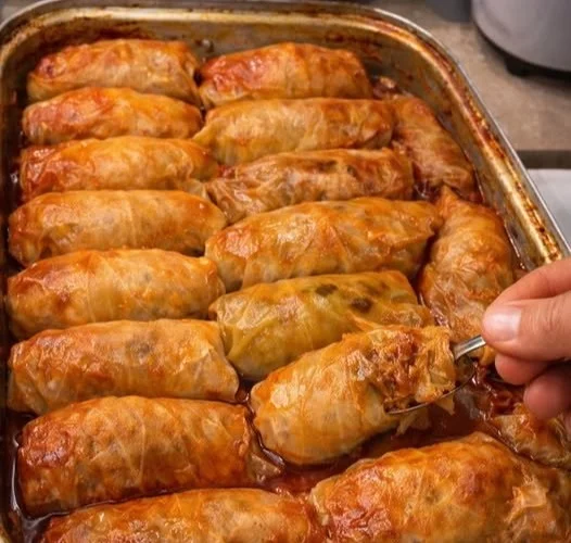 Traditionelle Omas Kohlrouladen, serviert auf einem Teller mit Sauce.